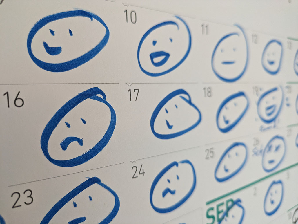 a calendar with a simple smily or frowny face on each day