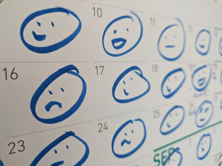 a calendar with a simple smily or frowny face on each day
